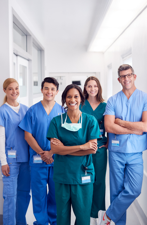 Image of healthcare workers posing and smiling for a group photo.